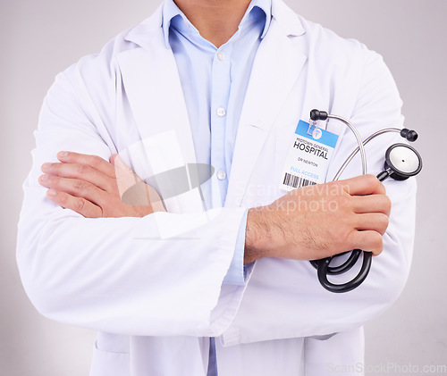 Image of Arms crossed, stethoscope and man doctor in studio for healthcare, examination or check up on grey background. Hands, cardiovascular or health by medical expert ready for consultation, exam or help
