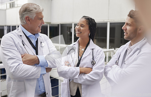 Image of Discussion, healthcare and team of doctors in the hospital talking in hallway after consultation. Collaboration, teamwork and group of professional medical workers in conversation in medicare clinic.