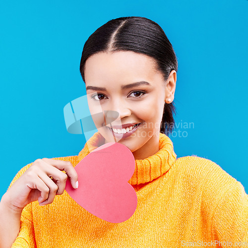 Image of Paper heart, portrait and happy woman on blue background, love icon and romantic flirting sign. Female model, emoji shape and smile of care, support and thank you for kindness, valentines day or date