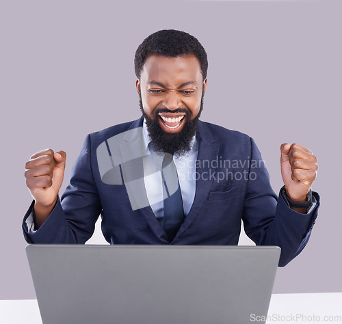 Image of Laptop, celebration and black man in business, studio or achievement of target, goals or motivation. Happy male worker, computer or celebrate success of winner, bonus or fist of winning surprise deal