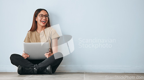 Image of Thinking, floor and woman laughing with laptop in home by wall background with mockup. Happiness, computer and funny person sitting on ground with pc for online meme, social media and comedy idea.