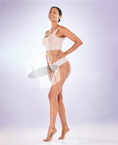 Image of Portrait, proud and underwear with a model woman in studio on a gray background to promote skincare. Body, wellness and natural with an attractive young female posing in lingerie for hair removal