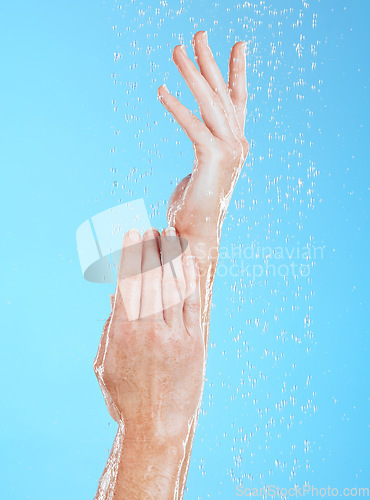 Image of Woman, hands and water drops, hygiene and handwashing, skincare and moisture on blue background. Natural, sustainability and wellness with eco friendly dermatology, shower and cleaning for health