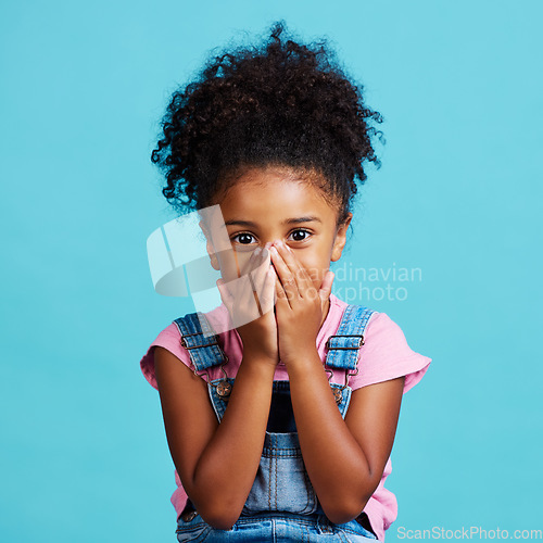 Image of Children, portrait and wow with a girl on a blue background in studio looking surprised or in shock. Face, hands and gossip with a cute little female child reacting to good news or an announcement