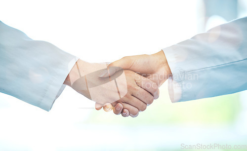 Image of Doctor, handshake and meeting in partnership for deal, b2b or agreement in healthcare collaboration at the hospital. Medical team shaking hands in teamwork support, hiring or promotion at the clinic