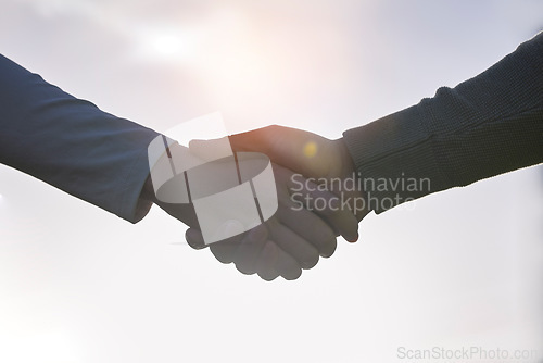 Image of Handshake, agreement and people partnership, outdoor teamwork and collaboration for onboarding or b2b. Business person, professional partner and shaking hands welcome, thank you or deal in lens flare