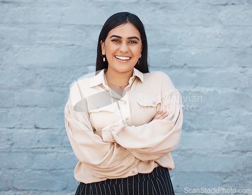 Image of Portrait, business woman and arms crossed on brick wall background with pride for career. Smile, professional and happiness, proud and confident female entrepreneur from India with success mindset.