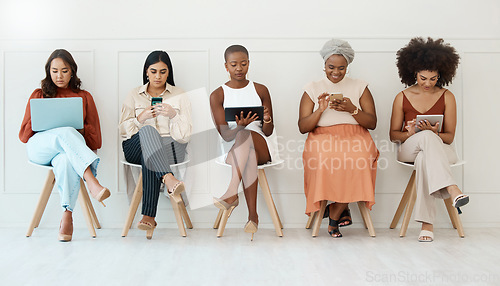 Image of Business woman, networking and communication in waiting room for social media, career opportunity or job search at office. Employee women busy on multimedia devices for mobile app or network in a row