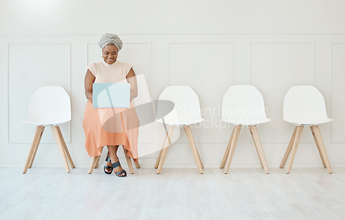 Image of Happy, recruitment and a black woman in a waiting room with a laptop typing an email. Smile, business and an African corporate employee with a computer for an interview, job search and reading notes