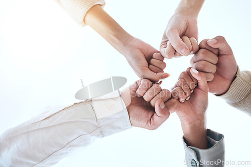 Image of Below business people, fist bump and circle for team building, support and group goals in workplace. Men, women and teamwork with solidarity for success, motivation and trust with diversity at job