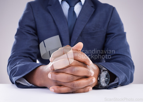 Image of Man, hand and angry hr in meeting for compliance, complaint or discipline against a wall background. Hands, together and boss waiting for bad behavior discussion in the workplace, bullying or fired