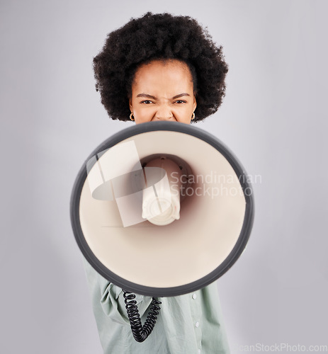 Image of Megaphone, protest and black woman shouting in portrait in studio isolated on a white background. Screaming, angry and person with loudspeaker protesting for change or justice, announcement or speech