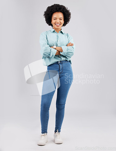 Image of Fashion, beauty and woman in a studio with a casual, stylish and trendy outfit with a jeans and shirt. Happy, smile and portrait of an African female model with style isolated by a gray background.