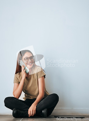 Image of Phone call, floor and happy woman talking in home by wall background with mockup. Cellphone, thinking and person smile while sitting on ground, discussion or conversation, chatting or speaking online