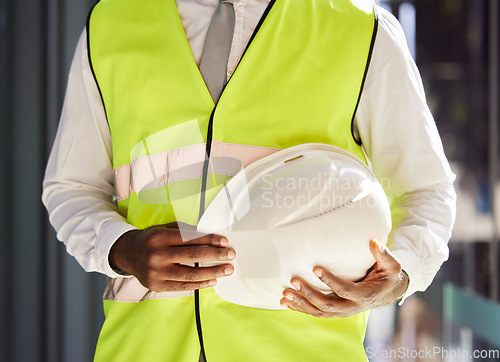 Image of Property development, architect and hands with a safety helmet for construction and engineering. Building, black man and business developer ready for real estate and infrastructure renovation