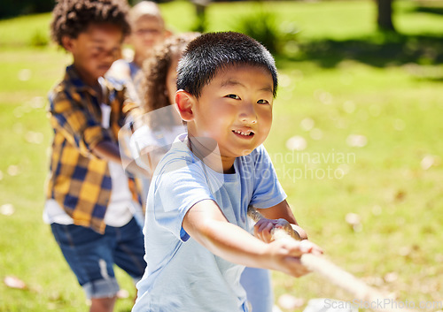 Image of Fun, games and children playing tug of war together outdoor in a park or playground during summer. Friends, diversity and kids pulling a rope while having fun or bonding in a garden on a sunny day