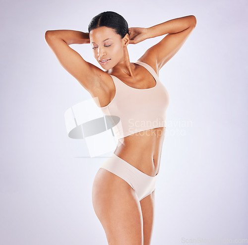 Image of Body, woman and beauty of model in studio for healthy lifestyle for weight loss, diet or fitness. Female on a white background for stomach or health, wellness and skin care motivation in underwear