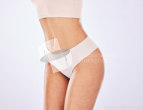 Image of Woman, body and stomach in studio for diet, weight loss or fitness motivation. Healthy female model on a white background for health, wellness and beauty in underwear for self care or shape mockup