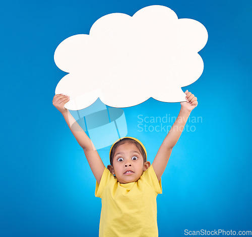 Image of Speech bubble, surprise and portrait of child in shock for news, opinion and announcement on blue background. Talking, social media mockup and wow, omg and excited girl with poster board in studio