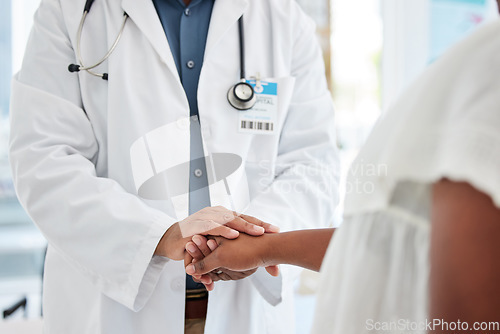 Image of Support, hands and doctor comforting a patient after a diagnosis at a consultation in the hospital. Wellness, compassion and male medical worker with empathy for a woman in a medicare clinic.