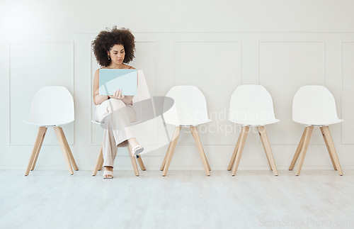 Image of Recruitment, laptop and woman in waiting room for interview, hiring or job opportunity in office. Computer, hr and business person typing online while sitting on chair for employment in workplace.