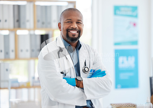 Image of Portrait, doctor smile and black man with arms crossed, pride for career, occupation or job in clinic. Healthcare, mature person and happiness, proud and confident medical professional from Nigeria.