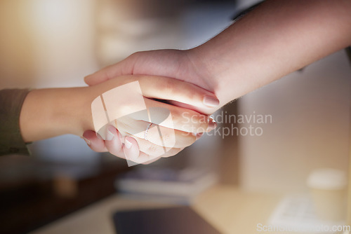 Image of Partnership, handshake and closeup on business people for office agreement, deal or thank you at night. Employees shaking hands in collaboration, welcome or team support of trust, promotion and hello