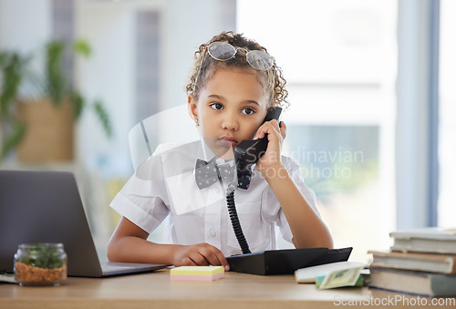 Image of Kids, phone call and a girl playing in an office as a fantasy businesswoman at work on a laptop. Children, telephone and a female child working at a desk while using her imagination to pretend