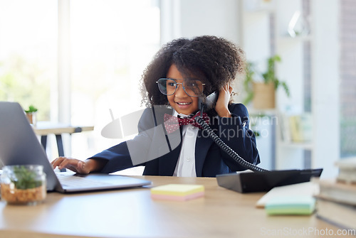 Image of Young child, playing office and phone call with laptop for networking, contact or communication. Girl, smile and listening for deal, negotiation and reading website on computer at desk in workplace