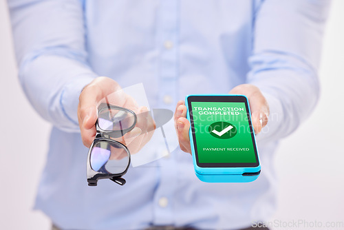 Image of Man, hands and phone with transaction approval or glasses for ecommerce or purchase against a white studio background. Hand of male holding spectacles and mobile smartphone for electronic payment
