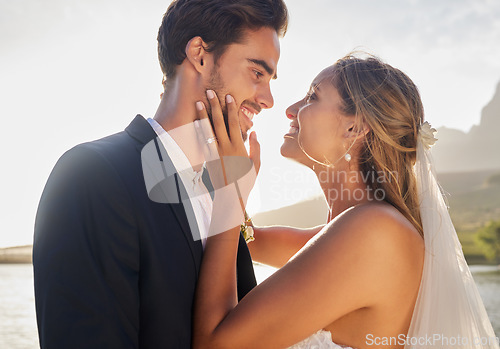 Image of Wedding, happy couple and lake with a bride feeling love, care and support from marriage together. Nature, happiness and romantic embrace of young people with a smile from trust and commitment event