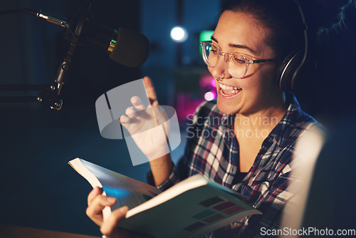 Image of Radio dj, presenter and woman in a sound production studio reading a book with happiness. Headphones, recording and working female employee with discussion on air for web podcast and books talk