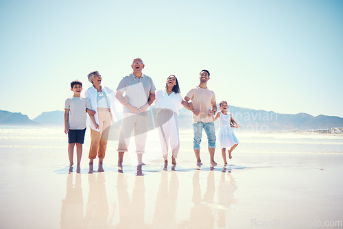 Image of Portrait of big family on beach walking together, grandparents and parents with kids smile together on vacation. Sun, fun and ocean happiness for hispanic men, women and children on summer holiday.