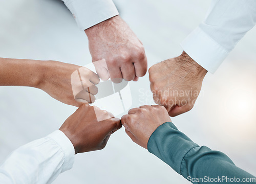 Image of Teamwork, fist bump and hands of business people together for motivation, support and community. Collaboration, team building and top view of employees in circle for diversity, solidarity and goals
