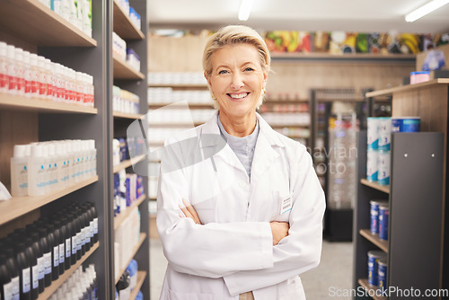 Image of Pharmacy, senior woman pharmacist in portrait at drug store and pills with medicine for healthcare. Drugs, health and arms crossed, pharmaceutical and happy with confident female medical professional