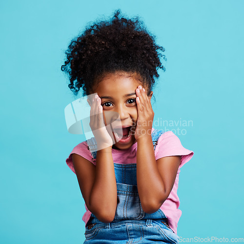 Image of Wow, expression and portrait of a child with shock isolated on a blue background in a studio. Happy, cute and face of a little girl with surprise, good news reaction and amazement on a backdrop