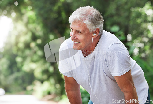 Image of Senior man, tired and outdoor with music earphones for run, workout and training on road for fitness. Elderly male person happy about cardio exercise for health and wellness on running, rest or break