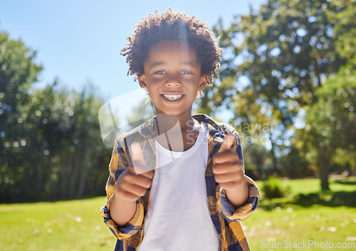 Image of Happy child, portrait or boy with thumbs up in park for a fun activity or playing in nature or summer. Excited young African kid smiling on holiday outside with success, happiness or achievement