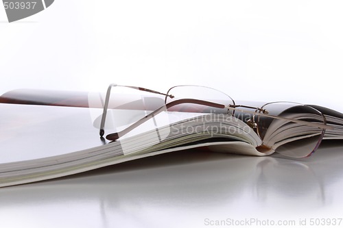 Image of Open book with glasses