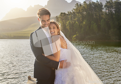 Image of Happy, hug and lake with a couple after a wedding for a ceremony, celebration and marriage. Smile, affection and funny with a man and woman laughing after a romantic relationship commitment in nature