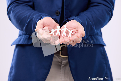 Image of Family, paper cutout in hands and connection with man, life insurance and community with support and childhood. Love, safety and link, male on studio background with parenthood and icon in palm