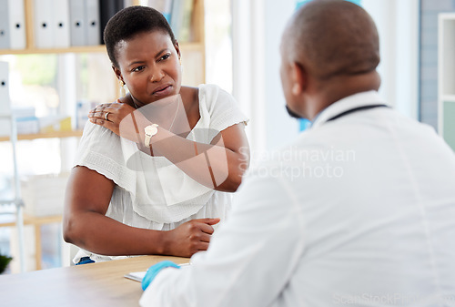Image of Healthcare, consultation and woman with shoulder pain at the doctor in the hospital for treatment. Sick, conversation and female patient with back injury getting checkup with medical worker in clinic
