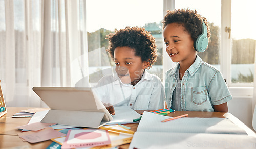 Image of Tablet, headphones and children doing a elearning class together in the dining room at home. Technology, online school and boy kids or brothers watching virtual lesson on mobile device in their house