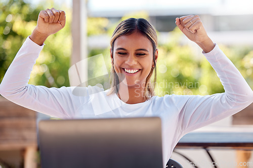 Image of Winner, laptop and cheering with a freelance woman remote working from a cafe on her small business startup. Wow, motivation or celebration with an attractive young female entrepreneur at work online