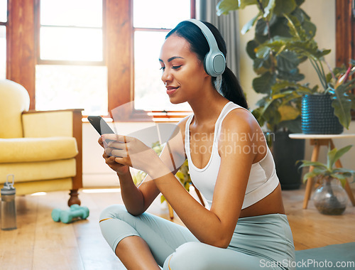 Image of Headphones, phone and yoga woman listening to meditation music, podcast or wellness audio for mental health. Fitness, exercise and pilates person typing on cellphone for music streaming on mobile app