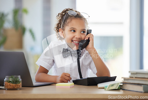 Image of Children, telephone and a girl playing in an office as a fantasy businesswoman at work on a laptop. Kids, phone call and a female child working at a desk while using her imagination to pretend