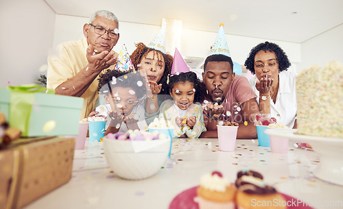 Image of Birthday, party and confetti with family in kitchen for celebration, bonding and affectionate. Happiness, excited and grandparents with parents and child at home for surprise, fun and event