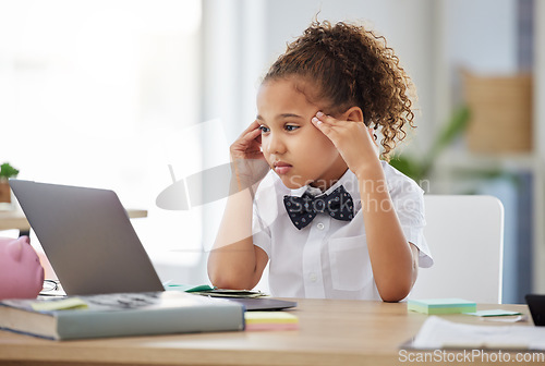 Image of Stress, laptop and child boss in the office while reading information on the internet for project. Corporate cosplay, frustration and young girl kid ceo working on a report with computer in workplace