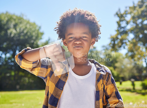 Image of Thumbs down, portrait or angry child in park unhappy, upset or frustrated in nature. Young African boy kid being negative by disagreeing with wrong sign, poor review or no body language