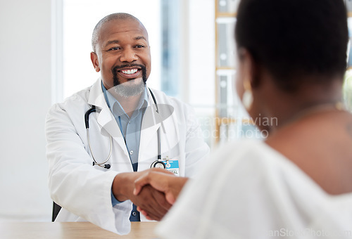 Image of Happy doctor, patient and handshake in healthcare visit, consultation or agreement at hospital. Black man, medical professional shaking hands with woman client for consulting, checkup or appointment